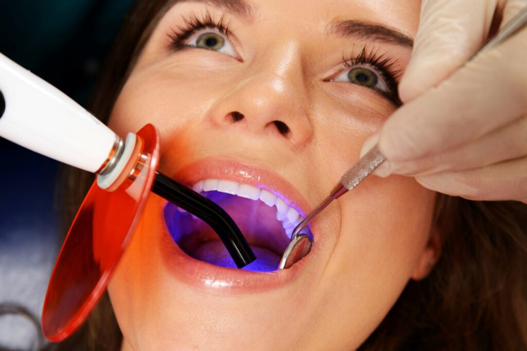 A woman a getting cosmetic dental bonding treatment
